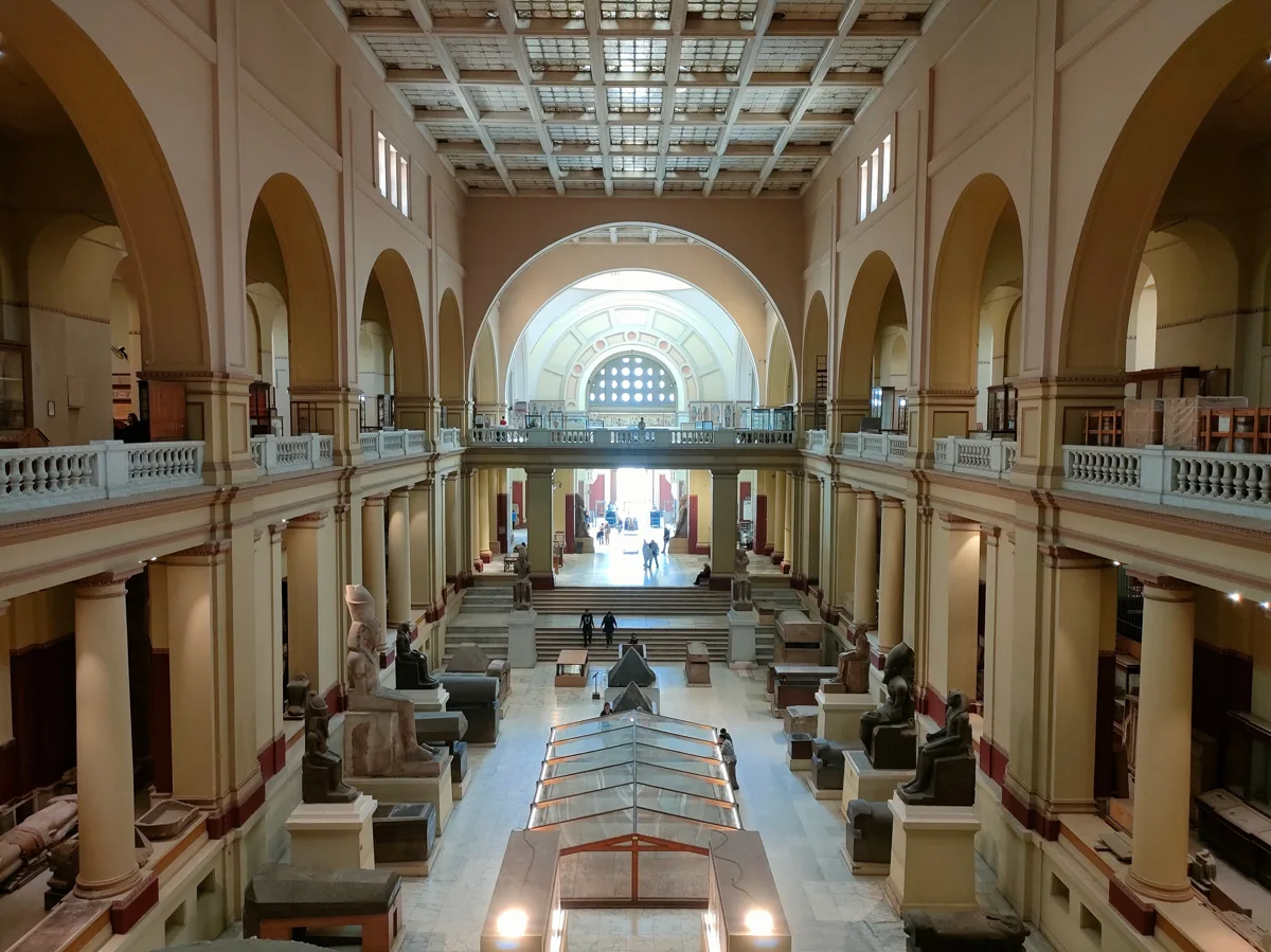 Grand interior hall of an Egyptian museum with display cases