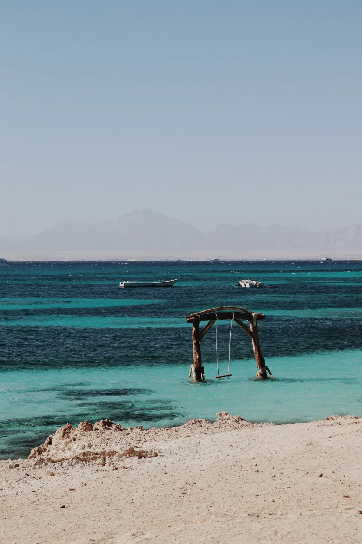 Turquoise Red Sea water with a swing in the shallows