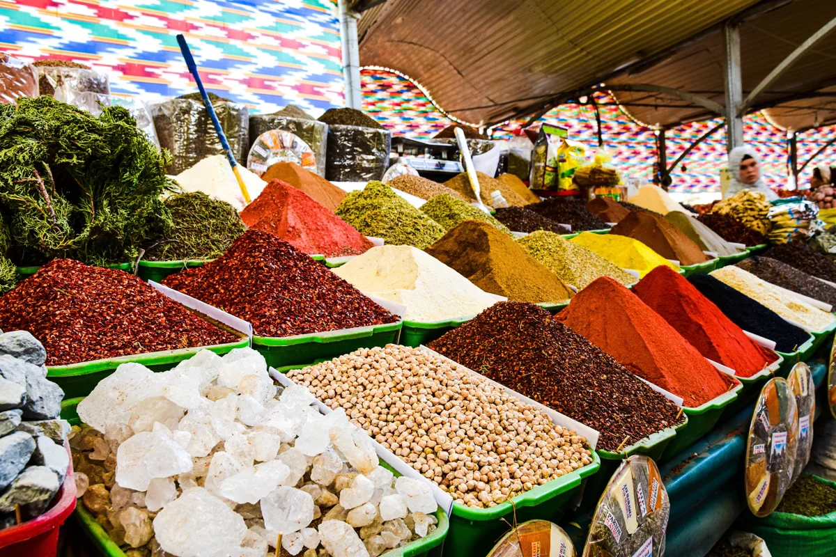 Open sacks of colorful spices at an Egyptian market stall