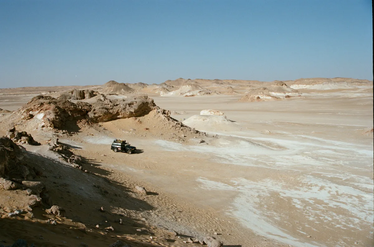Four-wheel-drive vehicle among White Desert chalk formations