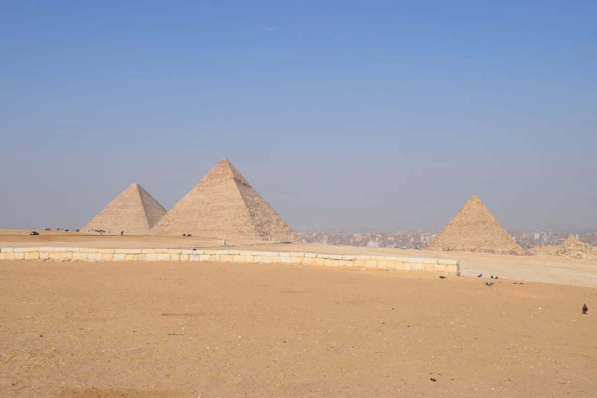 Giza pyramids viewed across the broad desert plateau