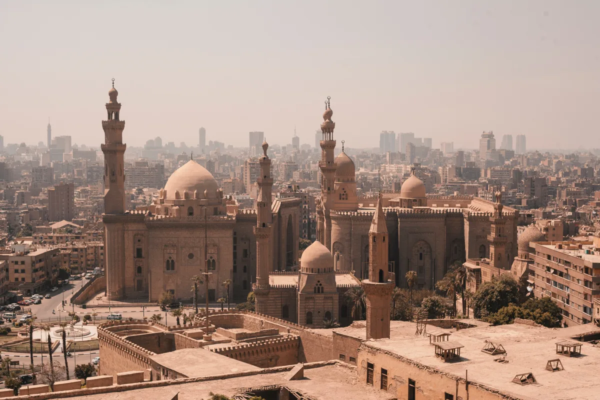 Panoramic Cairo skyline with historic mosques and minarets