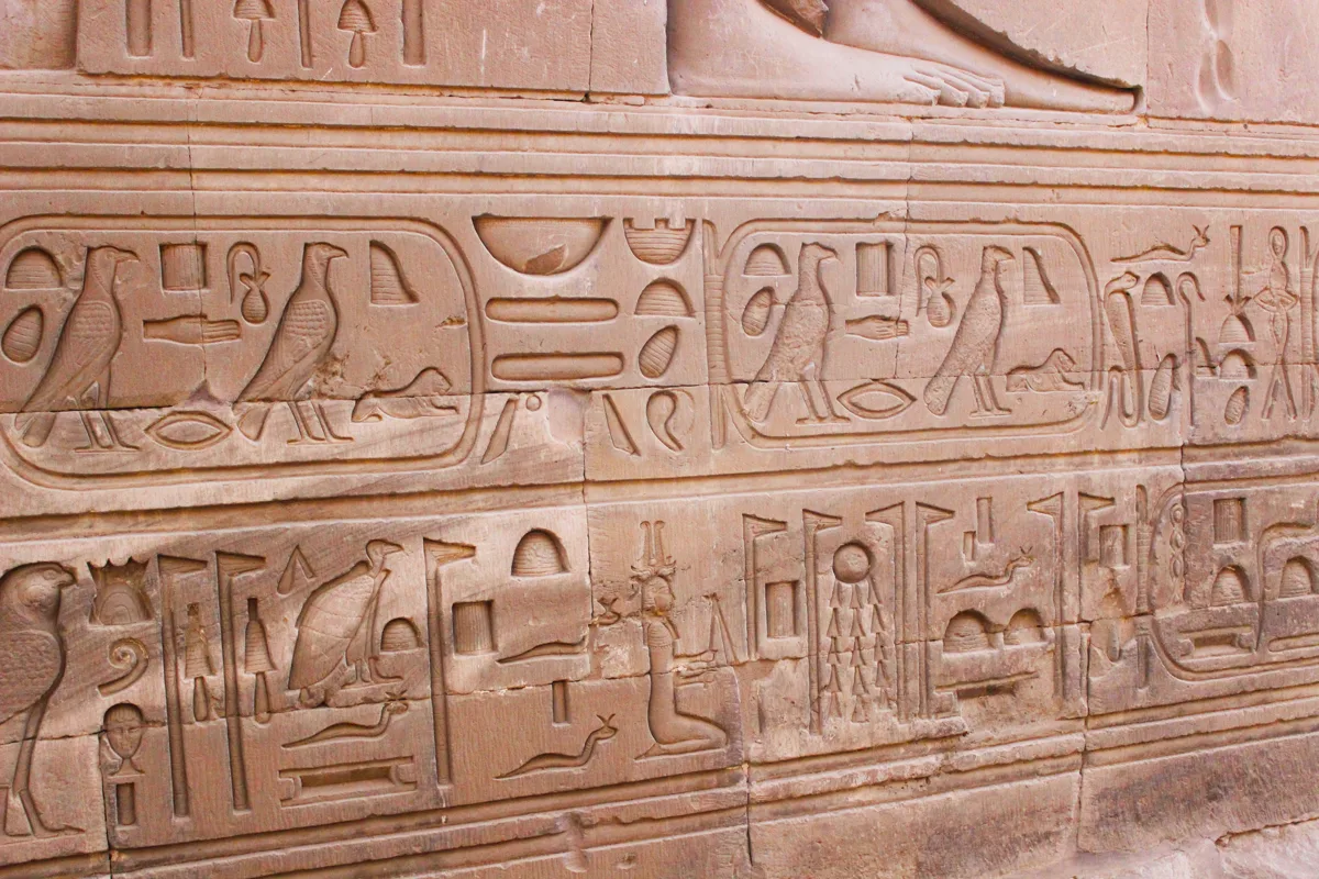 Carved hieroglyphs on an ancient Egyptian temple wall