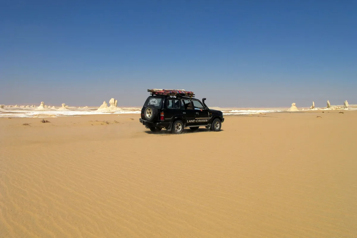 Four-wheel-drive vehicle crossing the White Desert sand
