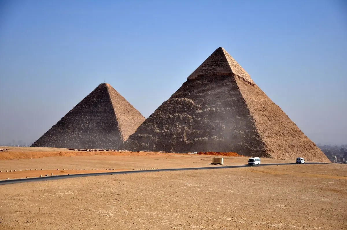 Three Giza pyramids viewed across the desert road